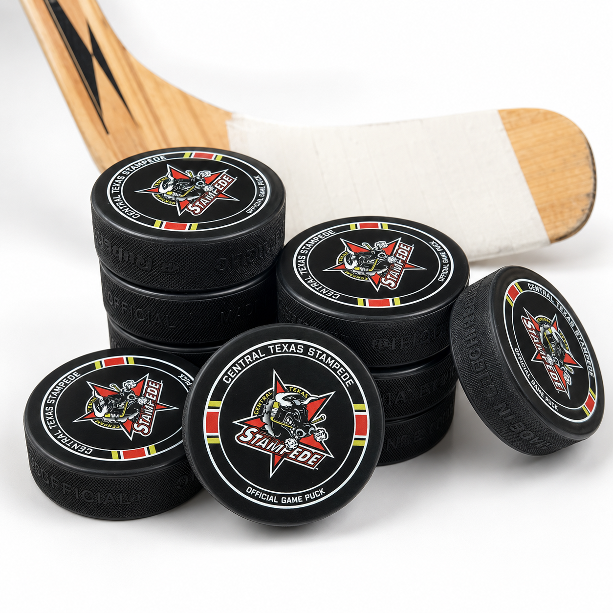 Stack view of the Stampede Hockey Puck with a hockey stick on white background